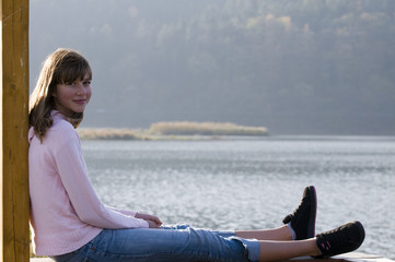 Fototapeta na wymiar Teenage girl portrait over lake