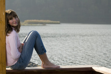 Fototapeta na wymiar Beautiful girl portrait over lake