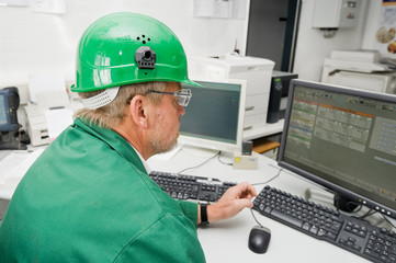 Industrial worker in his office in front of a pc