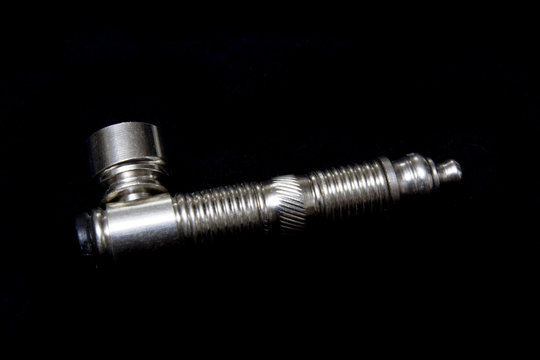 Chrome crack pipe isolated on a black studio background