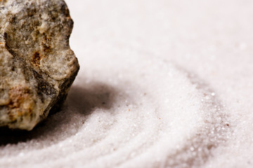 A zen rock garden background with white sand.
