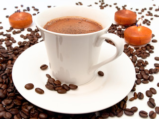 cup of coffee beans and candles