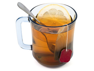 white cup of tea with lemon and spoon in it