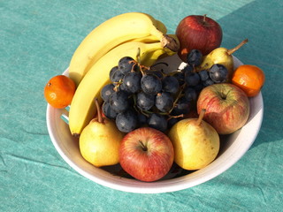 Fruit plate with grapes, bananas, apples, mandarin orange, pears