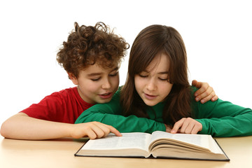 Fototapeta premium Kids learning at home, reading book - isolated on white