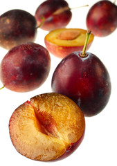 Detail purple plum with slice on white
