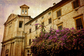 Fototapeta na wymiar Postcard from Italy. Church and bougainvillea Marches, Italy