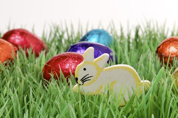 chocolate easter eggs and a bunny on grass