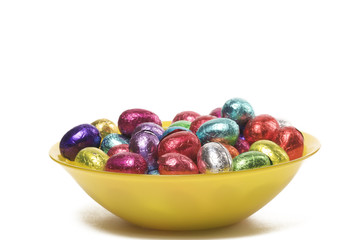 a dish filled with colorful easter chocolates