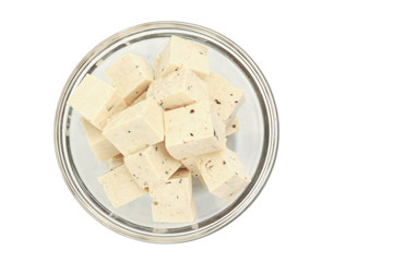 cube of fresh fine herbs tofu in a bowl, isolated on white