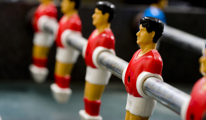 a row of foosball or table soccer playing pieces