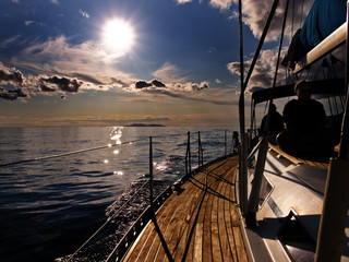 Sailing on the Adriatic at dusk with silhouette of girl.