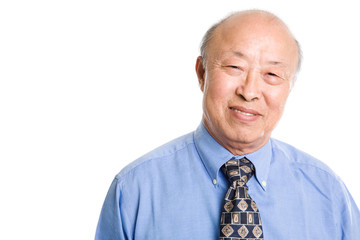 An isolated shot of a smiling senior asian businessman