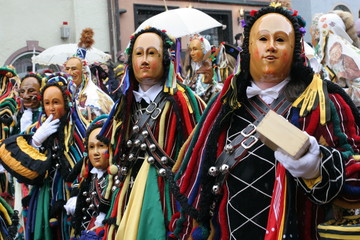 Traditional carnival parade with carved wooden masks and historical costumes in the town of Rottweil, Germany