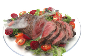 roast smoked meat and vegetables on transparent dish