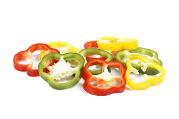 Rings of paprika reflected on white background. Shallow DOF