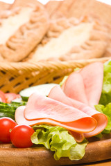 Fresh ham & salad on a wooden plate