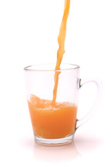 small transparent glass filled with orange juice