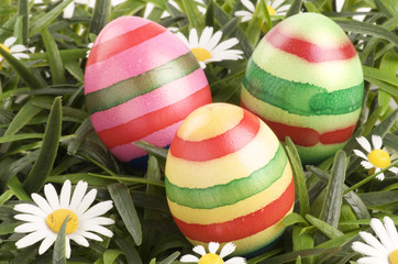 a group of colorful easter eggs lying on grass
