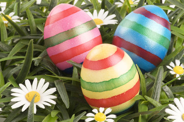 a group of colorful easter eggs lying on grass