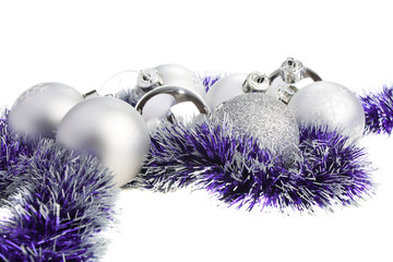 Silver Xmas balls and purple tinsel, isolated