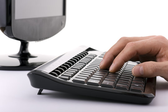 High key shot of hand on computer keyboard