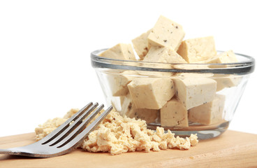 fresh fine herbs tofu in a bowl and wood plank with a fork
