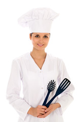Female chef holding cooking utensils