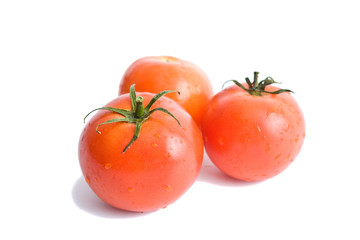 Three red tomatoes on a white background