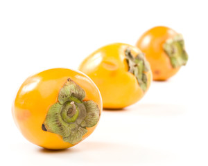 Fresh appetizing persimmon on a white background