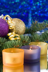 Decoration with an  firtree branch, candles and toys
