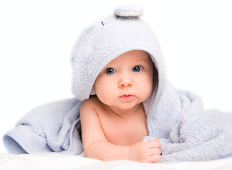 Cute baby girl with towel after bath. Studio shot. Isolated