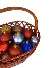 Basket with christmas balls isolated on white background