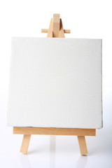 Empty artistst canvas on an easel, shot on white,