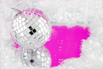 disco ball decoration with reflection surrounded by fake snow