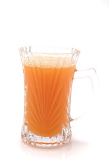 small transparent glass with orange juice