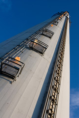 close view of a tall industrial chimney from the ground up