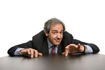mature business man on a desk, isolated on white