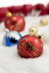 red merry christmas ball with christmas decoration on snow