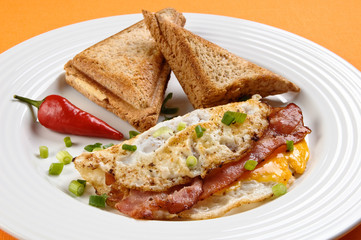 Breakfast - toasts, egg, bacon and vegetables