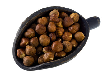 filberts (hazelnuts) on a wodden scoop, isolated on white