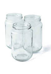 Three empty glass jars on white background