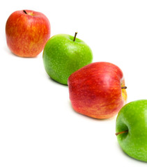 The red and green apples on white. Isolation, shallow DOF.