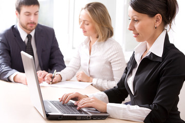 Fototapeta premium Businesswoman typing a letter on the background of people