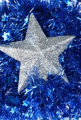 Silver flicker snowflakes on blue backgroung