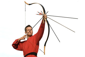 Low angle view of an archer pointing upwards