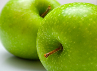 Green apples on the grey background. Shallow DOF