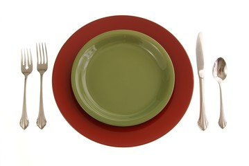 Red and Green table setting with plates and silverware on white