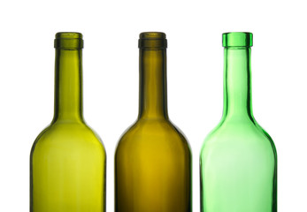 Three green empty wine bottles in a row.