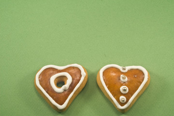 Two Christmas cookies on green background ad space above